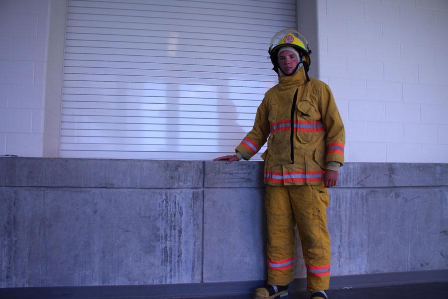 Senior Shaun Messer poses in his fire fighter equipment