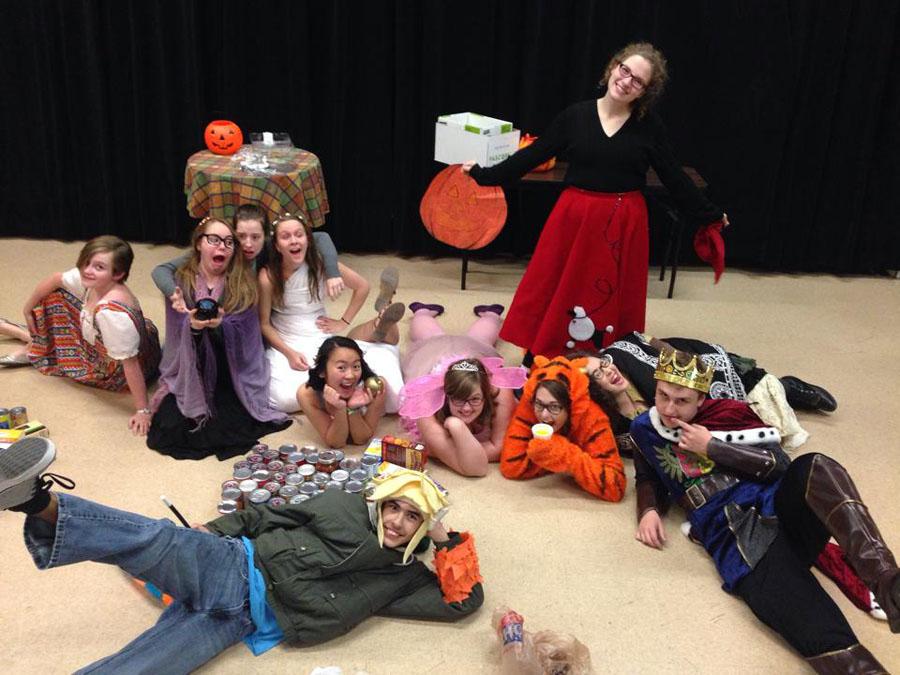 Thespians take a photo with the cans they collected