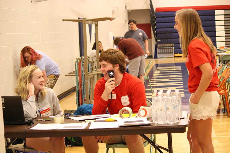 Junior Adelaide Bliss, senior Corbin Sedlacek and sophomre Joy Gruenbacher pay wit blood pressure detector while staffing the enterance table during the Blood Drive. The members of StuCo helped put on the blood drive.