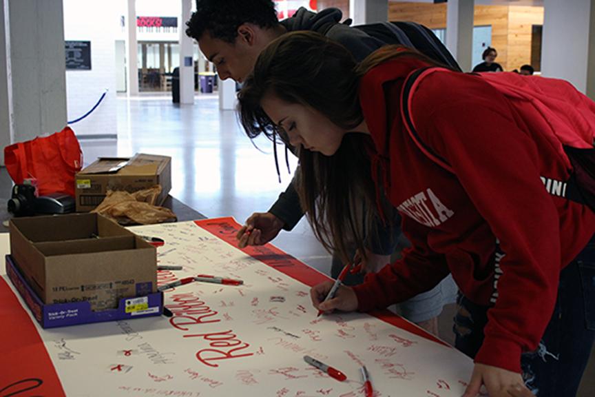 Seniors Madeline Stromlund and Michael Lopez pledge to stay drug free. On Tuesday, October 25, Manhattan High Students write their names down, pledging to stay drug free.